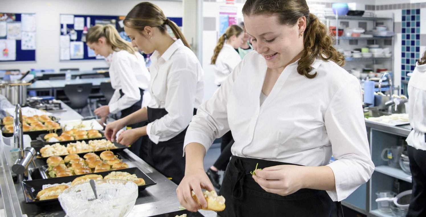 Hospitality students prepare food for service